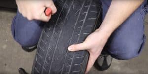 Insert the rasp tool into the tire hole